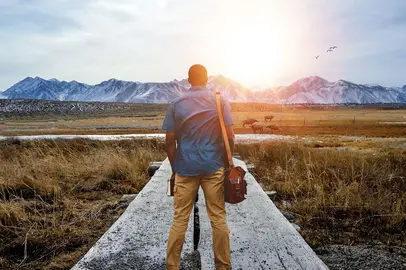 shallow-focus-from-behind-of-male-standing-on-pathway-in-the-middle-of-grassy-field_opt